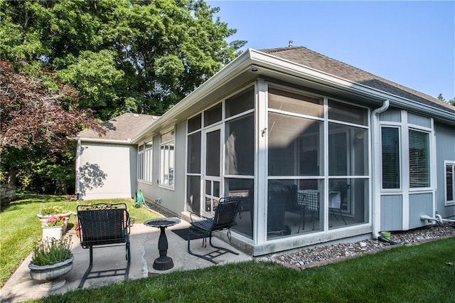 17801 E 30th St S, Independence, MO 64057 - view of side of property with a sunroom, a patio area, a shingled roof, and a yard