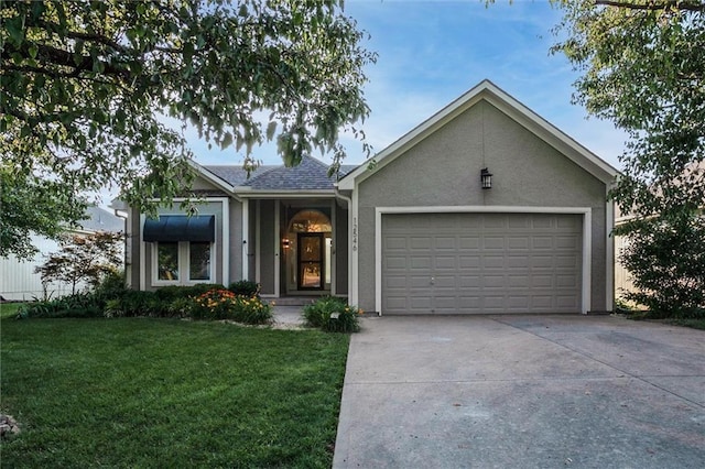 12546 Augusta Dr, Kansas City, KS 66109 - single story home featuring a front lawn, an attached garage, concrete driveway, and stucco siding