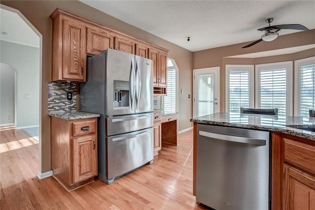 12546 Augusta Dr, Kansas City, KS 66109 - kitchen featuring appliances with stainless steel finishes, a ceiling fan, light wood-type flooring, and plenty of natural light