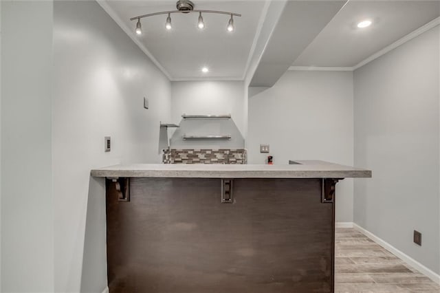 12546 Augusta Dr, Kansas City, KS 66109 - indoor bar with light wood finished floors, crown molding, and recessed lighting