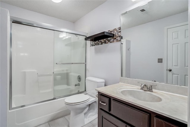 12546 Augusta Dr, Kansas City, KS 66109 - full bath with vanity, shower / bath combination with glass door, tile patterned flooring, and a textured ceiling