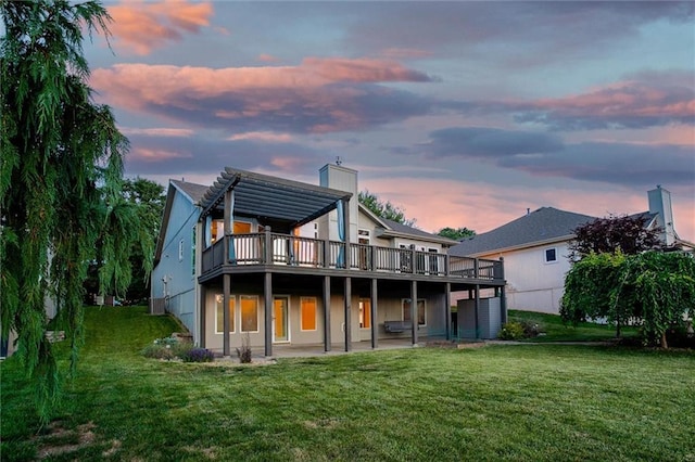 12546 Augusta Dr, Kansas City, KS 66109 - back of house featuring a deck, a lawn, and a chimney