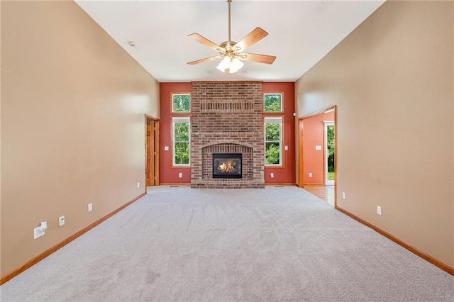 11180 Riverview Ave, Edwardsville, KS 66111 - unfurnished living room with a ceiling fan, light carpet, and a brick fireplace