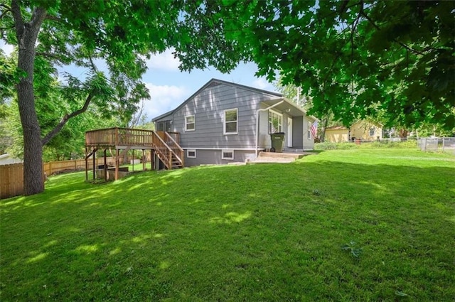 919 Walnut St, Leavenworth, KS 66048 - back of property featuring a fenced backyard, a wooden deck, and stairway