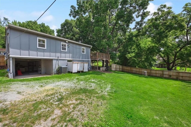919 Walnut St, Leavenworth, KS 66048 - rear view of house with board and batten siding, a deck, and a garage