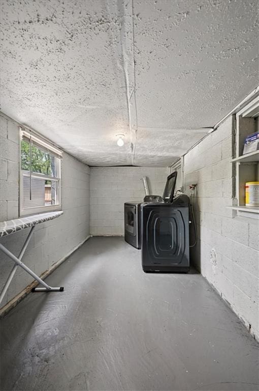 919 Walnut St, Leavenworth, KS 66048 - basement featuring washing machine and dryer, concrete block wall, and a textured ceiling