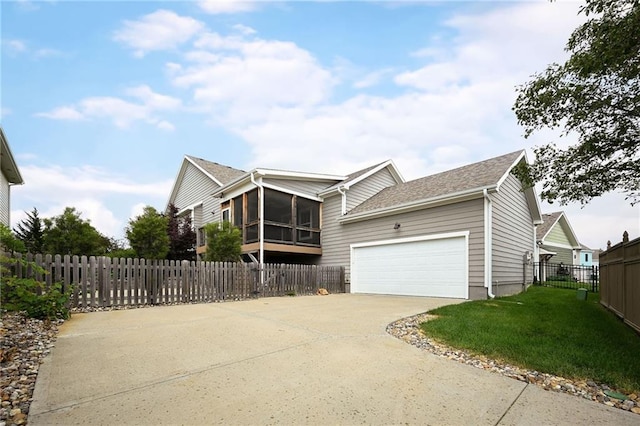 3225 SW Longview Rd, Lees Summit, MO 64081 - view of property exterior with a sunroom, concrete driveway, a garage, and roof with shingles