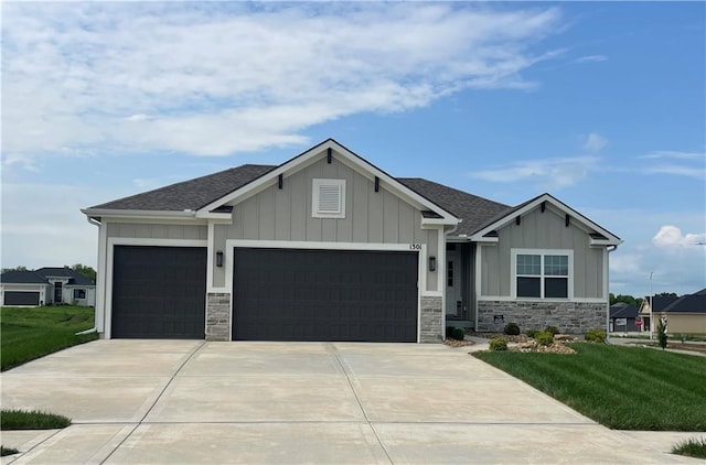 1301 NE 123rd St, Kansas City, MO 64165 - craftsman-style home with a garage, concrete driveway, stone siding, and board and batten siding