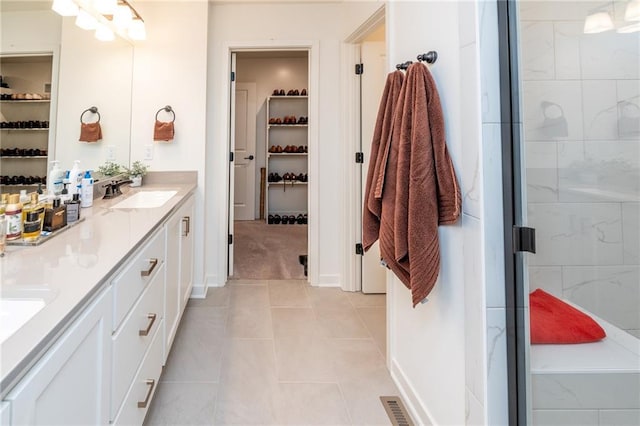 1301 NE 123rd St, Kansas City, MO 64165 - bathroom featuring double vanity, a spacious closet, a stall shower, and tile patterned floors