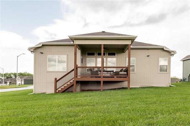 1301 NE 123rd St, Kansas City, MO 64165 - rear view of house with a deck, a yard, a ceiling fan, and a shingled roof
