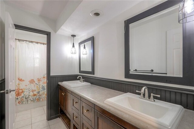 1108 NW Canterbury Rd, Blue Springs, MO 64015 - full bathroom featuring a wainscoted wall, double vanity, tile patterned floors, and a shower with shower curtain
