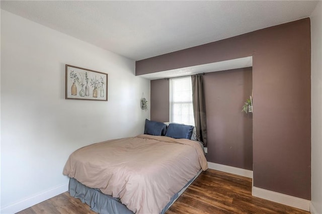 1108 NW Canterbury Rd, Blue Springs, MO 64015 - bedroom with baseboards and wood finished floors