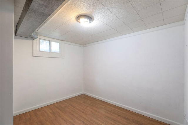 1108 NW Canterbury Rd, Blue Springs, MO 64015 - below grade area featuring wood finished floors and baseboards