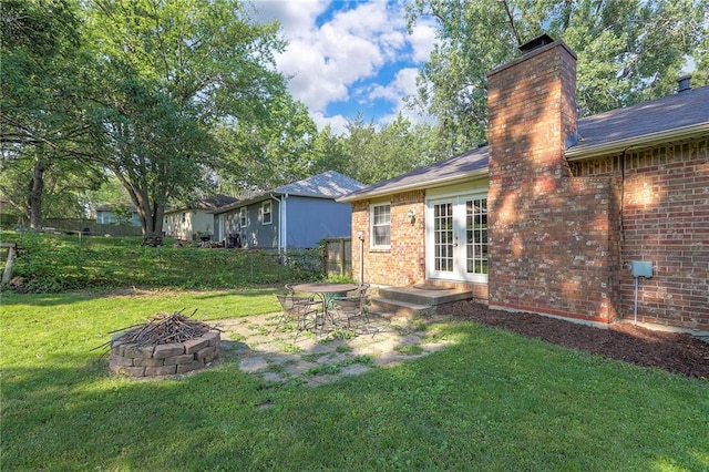 1108 NW Canterbury Rd, Blue Springs, MO 64015 - view of yard with french doors and a fire pit