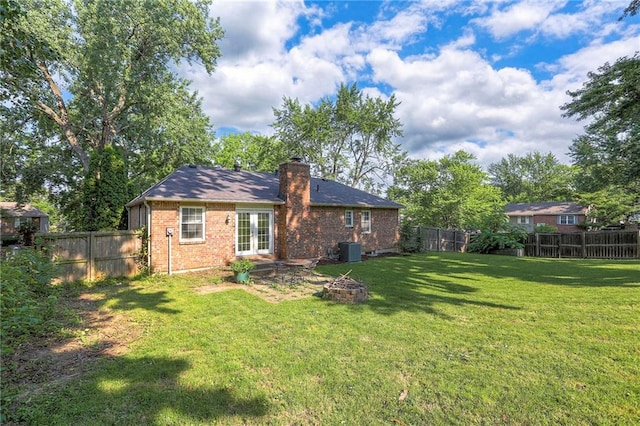 1108 NW Canterbury Rd, Blue Springs, MO 64015 - back of house with an outdoor fire pit, french doors, brick siding, and a fenced backyard