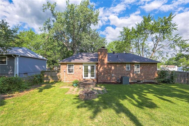 1108 NW Canterbury Rd, Blue Springs, MO 64015 - back of property featuring french doors, brick siding, a fenced backyard, and a chimney