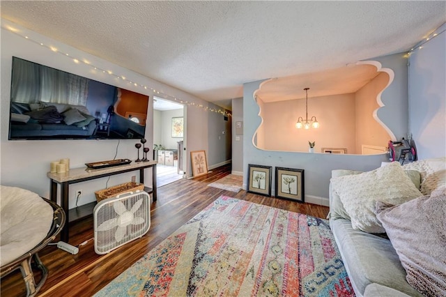 11400 Monroe Ave, Kansas City, MO 64137 - living room featuring a chandelier, a textured ceiling, and wood finished floors