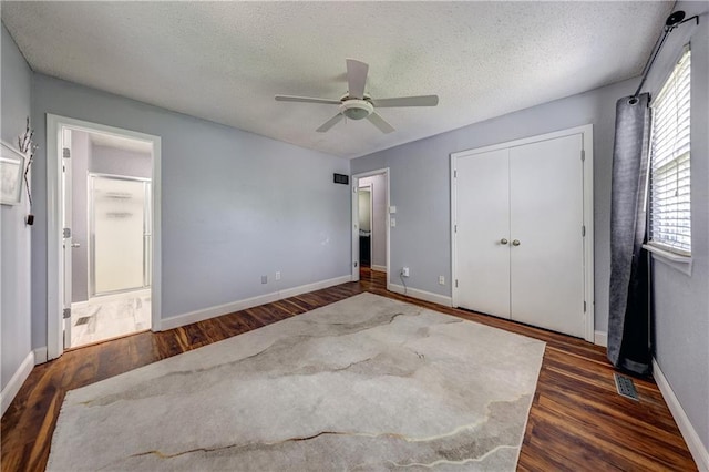 11400 Monroe Ave, Kansas City, MO 64137 - unfurnished bedroom with wood finished floors, a closet, a textured ceiling, ceiling fan, and ensuite bath