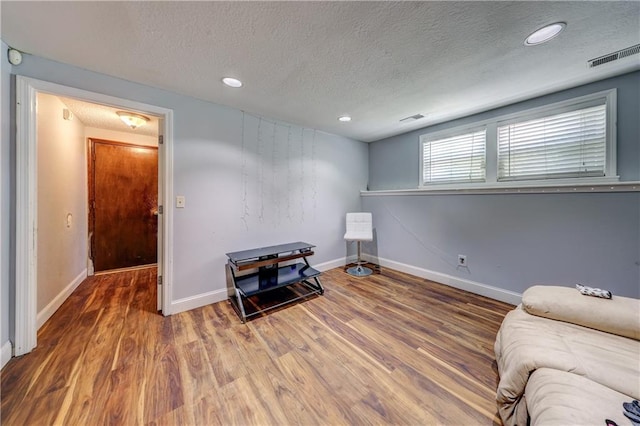 11400 Monroe Ave, Kansas City, MO 64137 - living area with a textured ceiling, wood finished floors, and recessed lighting