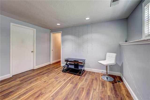 11400 Monroe Ave, Kansas City, MO 64137 - unfurnished room with wood finished floors, a textured ceiling, and recessed lighting