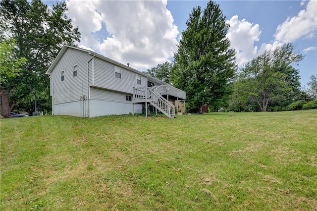 11400 Monroe Ave, Kansas City, MO 64137 - back of house with stairway, a wooden deck, and a yard