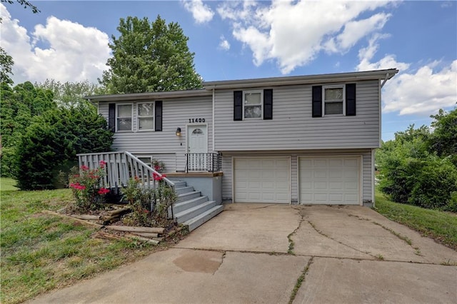 11400 Monroe Ave, Kansas City, MO 64137 - split foyer home featuring a garage and concrete driveway