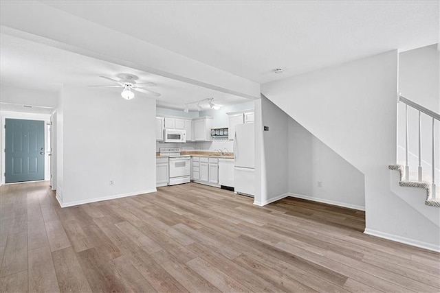 5626 NW Moonlight Meadow Ct, Lees Summit, MO 64064 - unfurnished living room featuring a ceiling fan, light wood-type flooring, and stairway