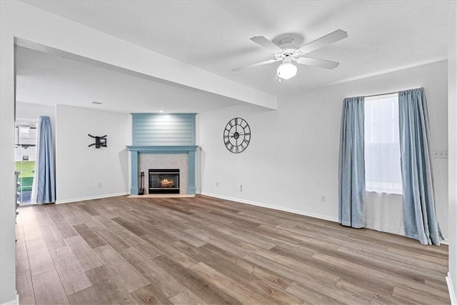 5626 NW Moonlight Meadow Ct, Lees Summit, MO 64064 - unfurnished living room with plenty of natural light, wood finished floors, a fireplace, and ceiling fan