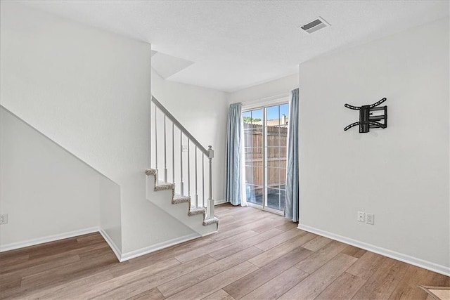 5626 NW Moonlight Meadow Ct, Lees Summit, MO 64064 - entryway with wood finished floors, stairway, and a textured ceiling