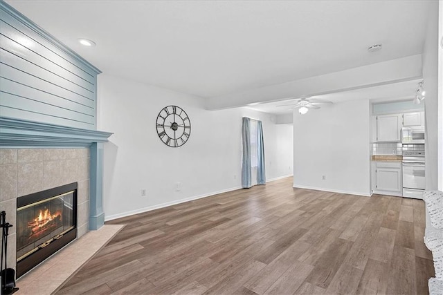 5626 NW Moonlight Meadow Ct, Lees Summit, MO 64064 - unfurnished living room with a fireplace, a ceiling fan, wood finished floors, and recessed lighting