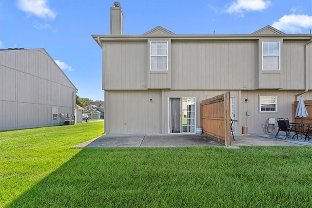 5626 NW Moonlight Meadow Ct, Lees Summit, MO 64064 - rear view of house featuring a patio, a lawn, and a chimney
