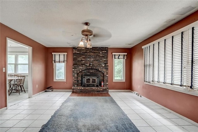 11301 Deer Haven Ln, Excelsior Springs, MO 64024 - unfurnished living room featuring light tile patterned floors, a ceiling fan, and a textured ceiling