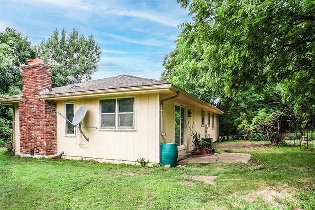 11301 Deer Haven Ln, Excelsior Springs, MO 64024 - view of property exterior featuring a lawn and a chimney