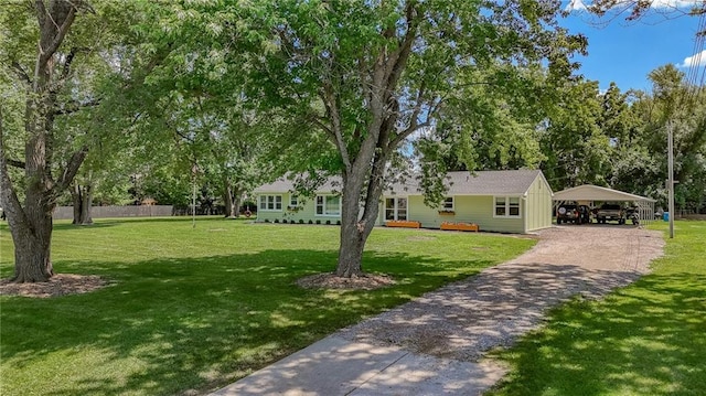 2633 E Langsford Rd, Lees Summit, MO 64063 - view of grassy yard featuring a carport and driveway