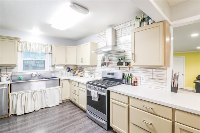 2633 E Langsford Rd, Lees Summit, MO 64063 - kitchen featuring stainless steel gas stove, wall chimney exhaust hood, tasteful backsplash, light countertops, and recessed lighting