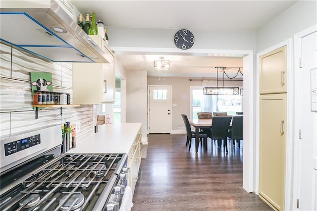2633 E Langsford Rd, Lees Summit, MO 64063 - kitchen with stainless steel gas range, exhaust hood, dark wood-style floors, and light countertops