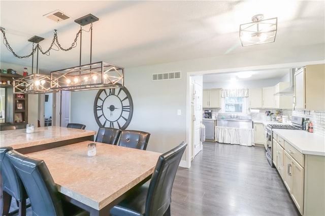 2633 E Langsford Rd, Lees Summit, MO 64063 - dining space with dark wood-style floors and a chandelier