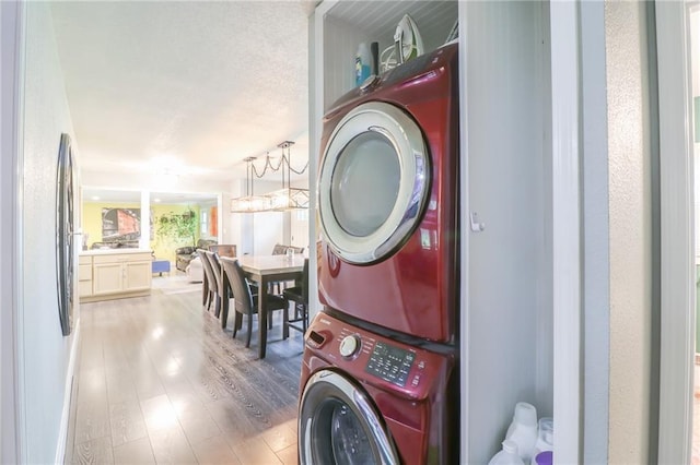 2633 E Langsford Rd, Lees Summit, MO 64063 - washroom featuring stacked washer / drying machine and wood finished floors