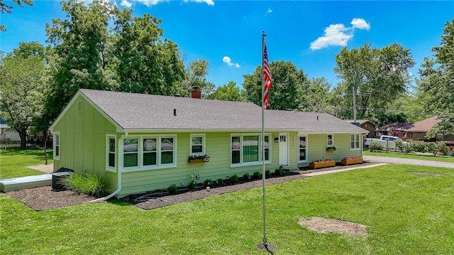 2633 E Langsford Rd, Lees Summit, MO 64063 - ranch-style home with board and batten siding, a front yard, a chimney, and roof with shingles