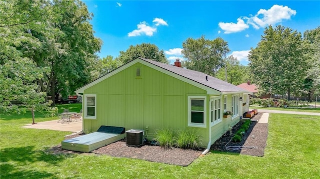 2633 E Langsford Rd, Lees Summit, MO 64063 - view of side of property with a patio, a lawn, and a chimney