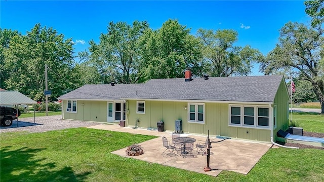 2633 E Langsford Rd, Lees Summit, MO 64063 - rear view of property featuring a lawn, board and batten siding, a shingled roof, a patio, and a chimney