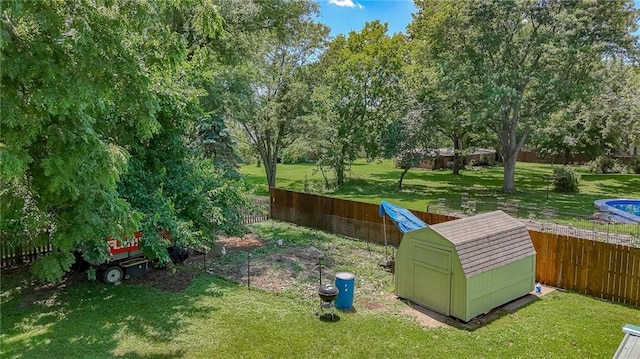 2633 E Langsford Rd, Lees Summit, MO 64063 - fenced backyard featuring a storage shed and view of wooded area