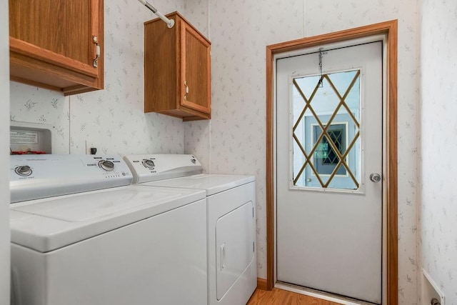 81 Enchanted Ln, Linn Valley, KS 66040 - laundry room featuring cabinet space, separate washer and dryer, wallpapered walls, and light wood finished floors