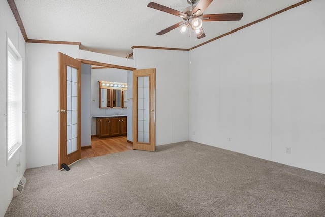 81 Enchanted Ln, Linn Valley, KS 66040 - unfurnished bedroom featuring carpet floors, ornamental molding, connected bathroom, french doors, and a textured ceiling