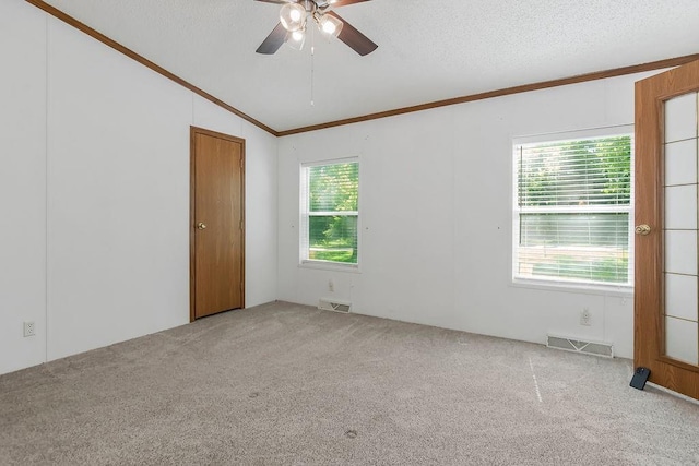 81 Enchanted Ln, Linn Valley, KS 66040 - spare room featuring crown molding, carpet flooring, ceiling fan, lofted ceiling, and a textured ceiling