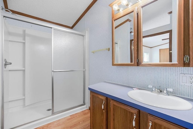 81 Enchanted Ln, Linn Valley, KS 66040 - full bathroom with a stall shower, vanity, crown molding, wood finished floors, and a textured ceiling