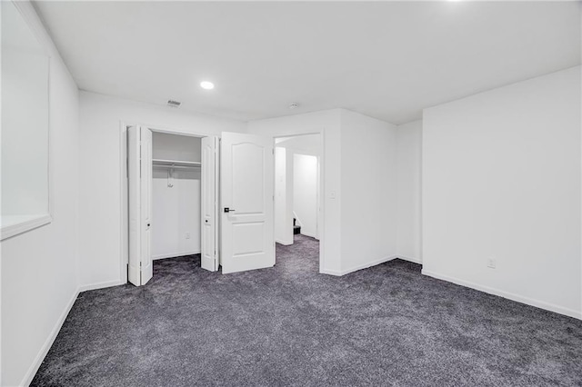 7210 E 134th Ter, Grandview, MO 64030 - unfurnished bedroom featuring dark carpet, recessed lighting, and a closet