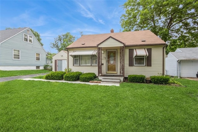 4234 E 68th St, Kansas City, MO 64132 - bungalow-style home featuring a front lawn and a chimney
