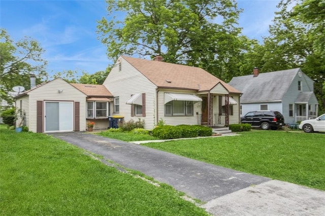 4234 E 68th St, Kansas City, MO 64132 - bungalow-style home with driveway, a front yard, a chimney, and roof with shingles