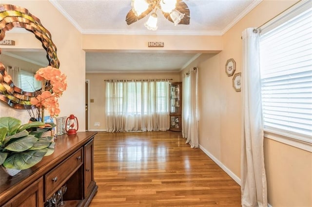 4234 E 68th St, Kansas City, MO 64132 - corridor featuring light wood-style flooring, ornamental molding, and a textured ceiling